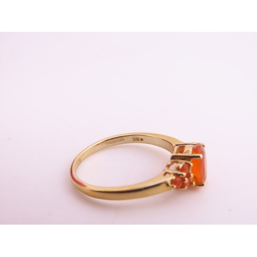 133 - A 9ct gold ring set with an oval fire opal within a decorative claw mount. Ring size M. Gross weight... 