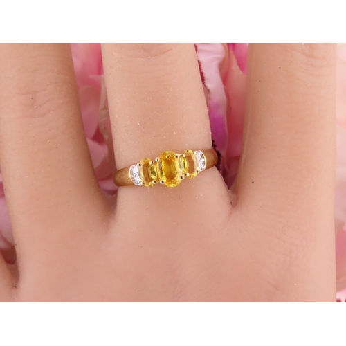 144 - A 9ct gold ring set with a citrine accented by small diamonds. Ring size M. Gross weight 1.9 grams.