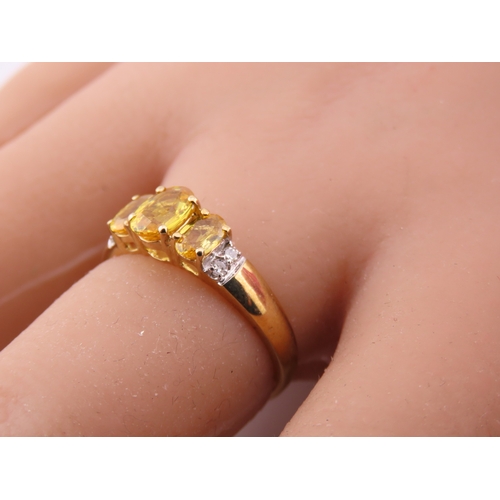 144 - A 9ct gold ring set with a citrine accented by small diamonds. Ring size M. Gross weight 1.9 grams.