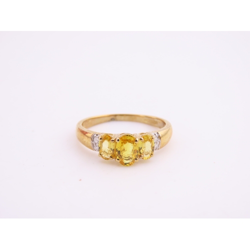 144 - A 9ct gold ring set with a citrine accented by small diamonds. Ring size M. Gross weight 1.9 grams.