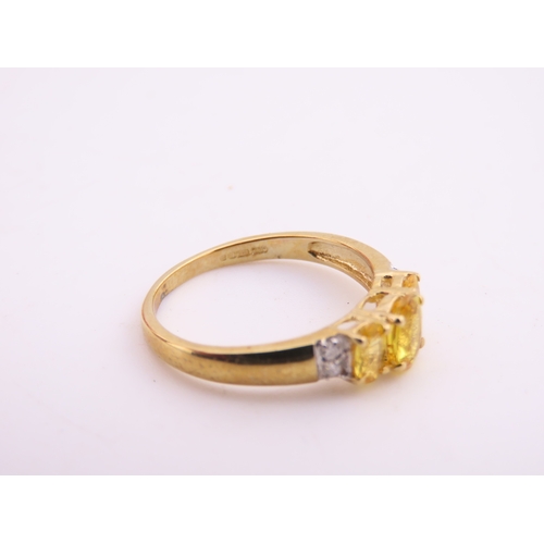 144 - A 9ct gold ring set with a citrine accented by small diamonds. Ring size M. Gross weight 1.9 grams.
