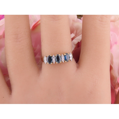 145 - A 9ct gold ring set with alternating sapphires and diamonds. Ring size M. Gross weight 1.7 grams.