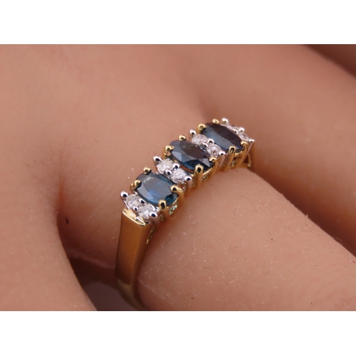 145 - A 9ct gold ring set with alternating sapphires and diamonds. Ring size M. Gross weight 1.7 grams.