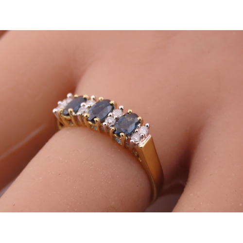 145 - A 9ct gold ring set with alternating sapphires and diamonds. Ring size M. Gross weight 1.7 grams.