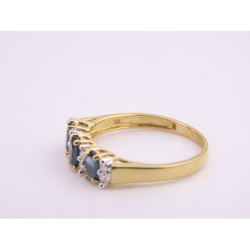 145 - A 9ct gold ring set with alternating sapphires and diamonds. Ring size M. Gross weight 1.7 grams.