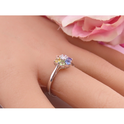 146 - An 18ct white gold floral cluster ring set with multiple gemstones forming a flower head. Ring size ... 