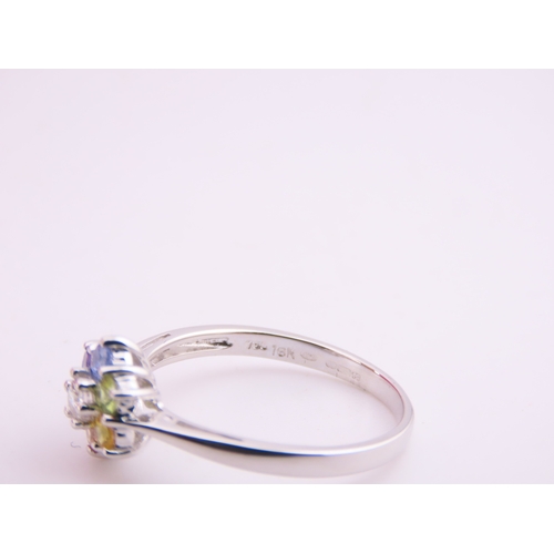 146 - An 18ct white gold floral cluster ring set with multiple gemstones forming a flower head. Ring size ... 