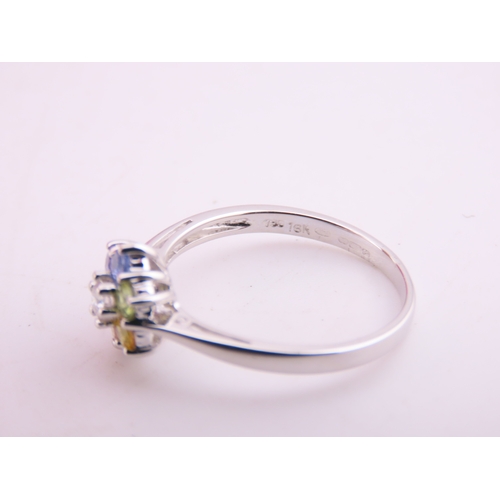 146 - An 18ct white gold floral cluster ring set with multiple gemstones forming a flower head. Ring size ... 