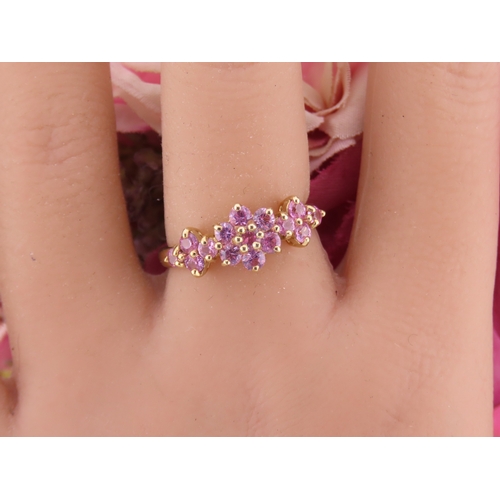 147 - A 9ct gold ring set with multiple pink sapphires in a decorative cluster. Ring size M. Gross weight ... 