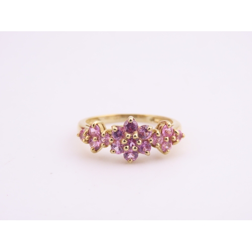 147 - A 9ct gold ring set with multiple pink sapphires in a decorative cluster. Ring size M. Gross weight ... 