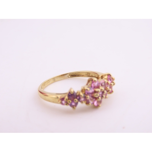 147 - A 9ct gold ring set with multiple pink sapphires in a decorative cluster. Ring size M. Gross weight ... 