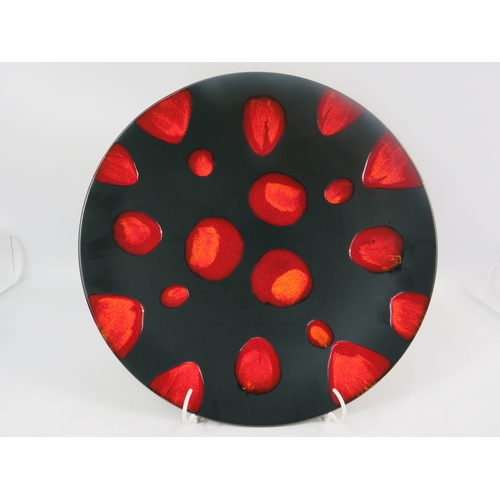 11 - Poole Pottery Galaxy charger with red abstract spots on black ground, 41cm diameter