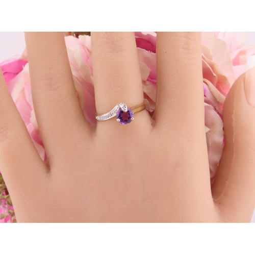 151 - 9ct Gold Amethyst and Diamond Ring. A delicate 9ct gold ring set with a round cut amethyst accented ... 