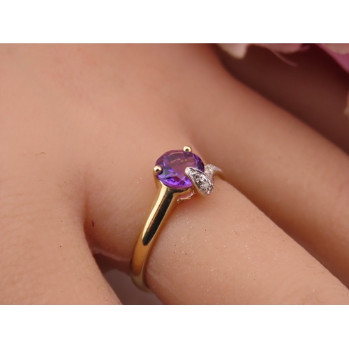 151 - 9ct Gold Amethyst and Diamond Ring. A delicate 9ct gold ring set with a round cut amethyst accented ... 