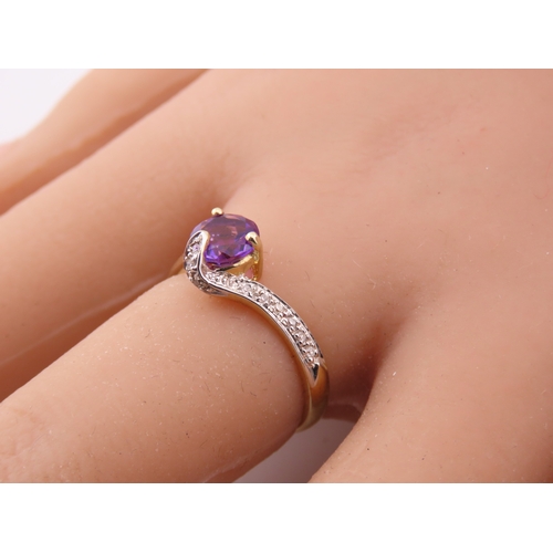 151 - 9ct Gold Amethyst and Diamond Ring. A delicate 9ct gold ring set with a round cut amethyst accented ... 