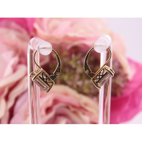 175 - Pair of 9ct Gold Smoky Quartz Earrings. Each set with an oval cut smoky quartz within a plain gold s... 