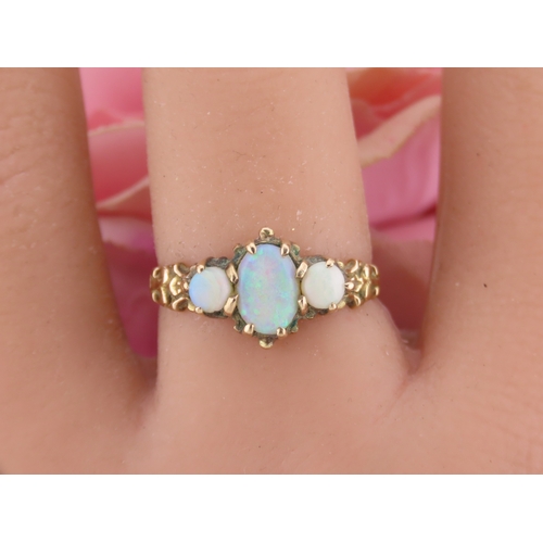 190 - A 9 carat gold opal trilogy ring, set with three graduated oval cabochon opals displaying characteri... 