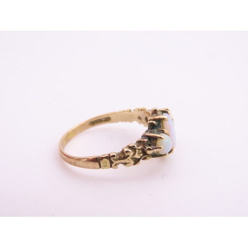 190 - A 9 carat gold opal trilogy ring, set with three graduated oval cabochon opals displaying characteri... 
