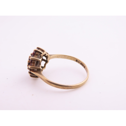 191 - A 9 carat gold garnet cluster ring, the central garnet surrounded by a halo of matching garnets in a... 