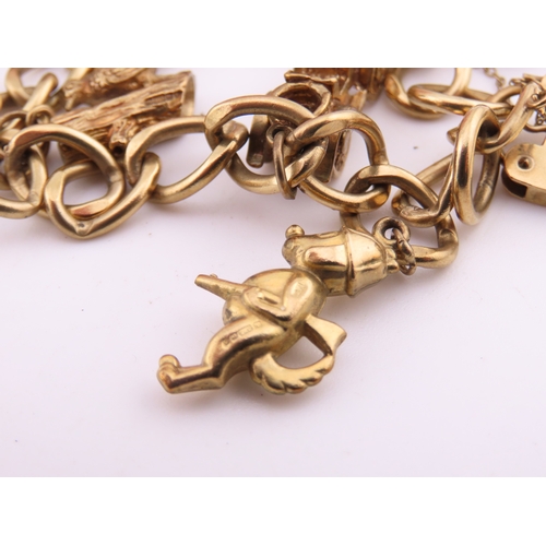 195 - A 9 carat gold charm bracelet, composed of a curb link chain fitted with a padlock clasp and suspend... 