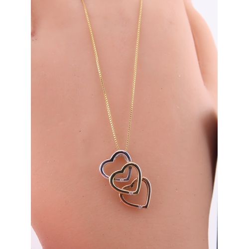 197 - A Brooks Bentley 9 carat tri colour gold heart pendant, formed as an interlocking three heart design... 