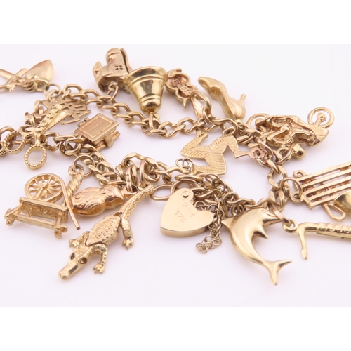 198 - A 9 carat gold charm bracelet, fitted with a padlock clasp and suspending seventeen assorted gold ch... 