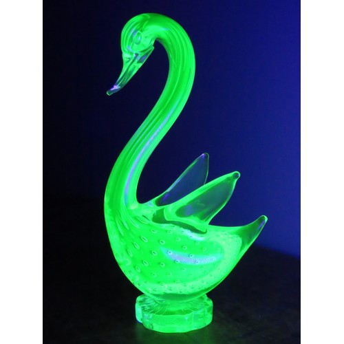 99 - A Murano uranium glass duck figure, of stylised form, raised on a circular base. Height approximatel... 
