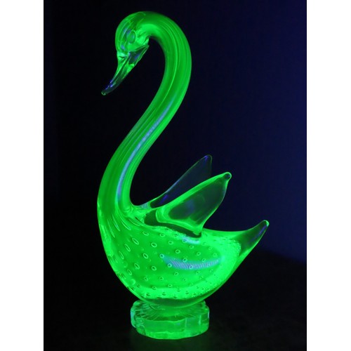 99 - A Murano uranium glass duck figure, of stylised form, raised on a circular base. Height approximatel... 