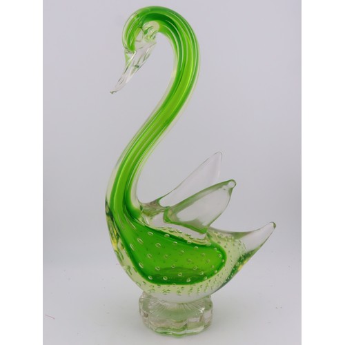 99 - A Murano uranium glass duck figure, of stylised form, raised on a circular base. Height approximatel... 