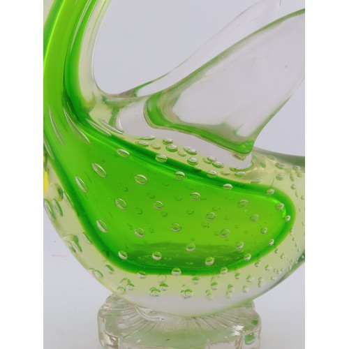 99 - A Murano uranium glass duck figure, of stylised form, raised on a circular base. Height approximatel... 