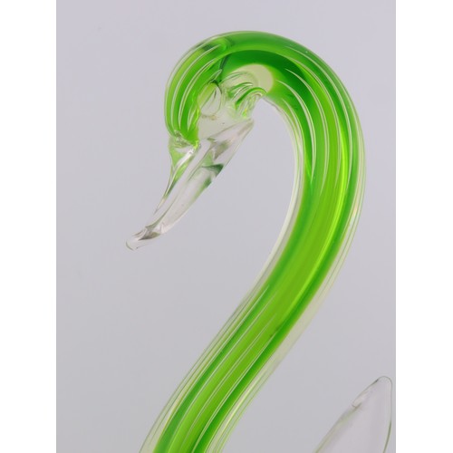 99 - A Murano uranium glass duck figure, of stylised form, raised on a circular base. Height approximatel... 