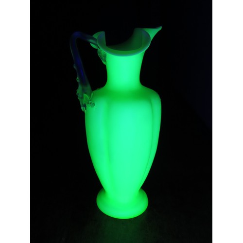 100 - A Victorian uranium glass jug, of baluster form with applied handle and butterfly and floral decorat... 