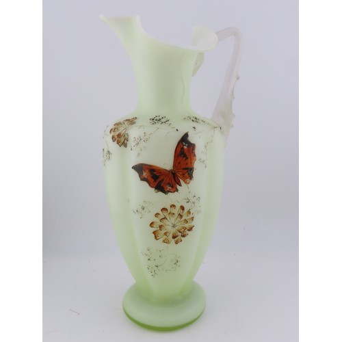100 - A Victorian uranium glass jug, of baluster form with applied handle and butterfly and floral decorat... 