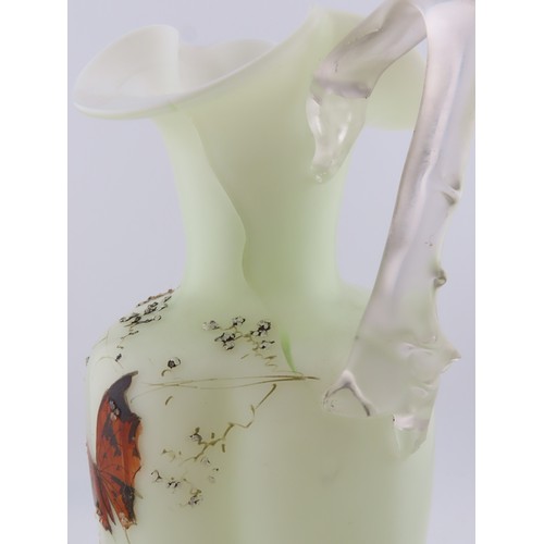 100 - A Victorian uranium glass jug, of baluster form with applied handle and butterfly and floral decorat... 