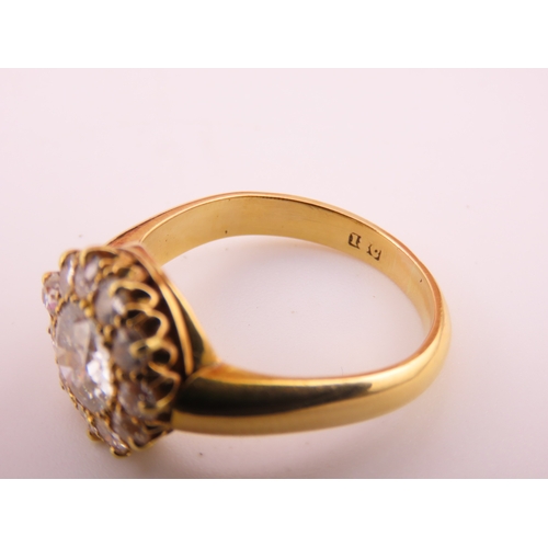 150A - A fine Victorian diamond cluster ring centred with a single old cut diamond surrounded by a border o... 