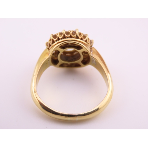 150A - A fine Victorian diamond cluster ring centred with a single old cut diamond surrounded by a border o... 