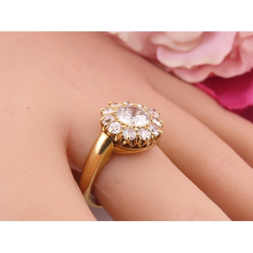 150A - A fine Victorian diamond cluster ring centred with a single old cut diamond surrounded by a border o... 