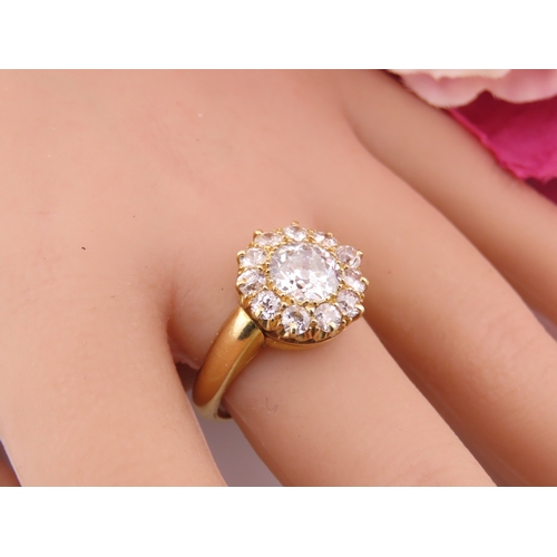 150A - A fine Victorian diamond cluster ring centred with a single old cut diamond surrounded by a border o... 