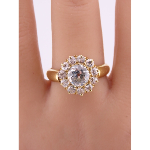 150A - A fine Victorian diamond cluster ring centred with a single old cut diamond surrounded by a border o... 