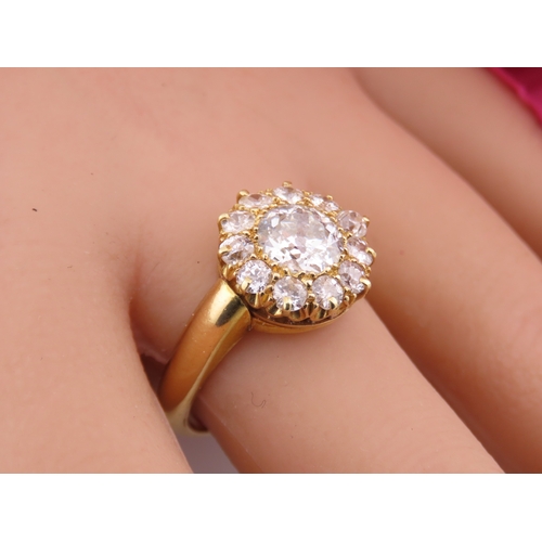 150A - A fine Victorian diamond cluster ring centred with a single old cut diamond surrounded by a border o... 