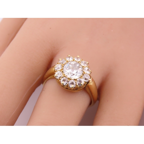 150A - A fine Victorian diamond cluster ring centred with a single old cut diamond surrounded by a border o... 