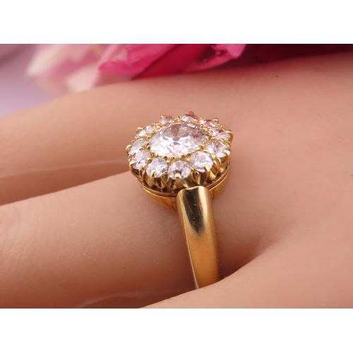 150A - A fine Victorian diamond cluster ring centred with a single old cut diamond surrounded by a border o... 
