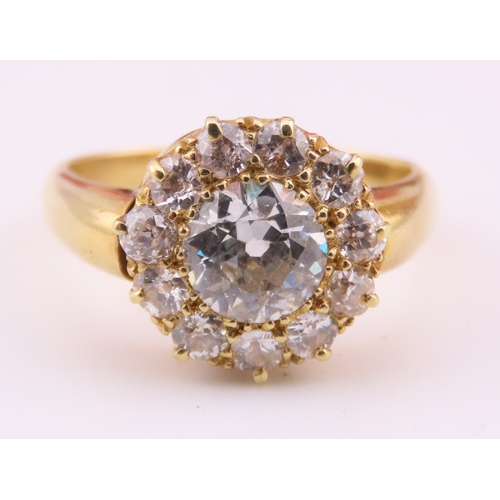 150A - A fine Victorian diamond cluster ring centred with a single old cut diamond surrounded by a border o... 