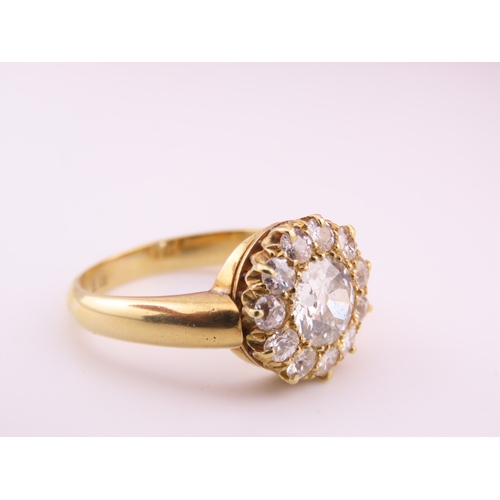 150A - A fine Victorian diamond cluster ring centred with a single old cut diamond surrounded by a border o... 