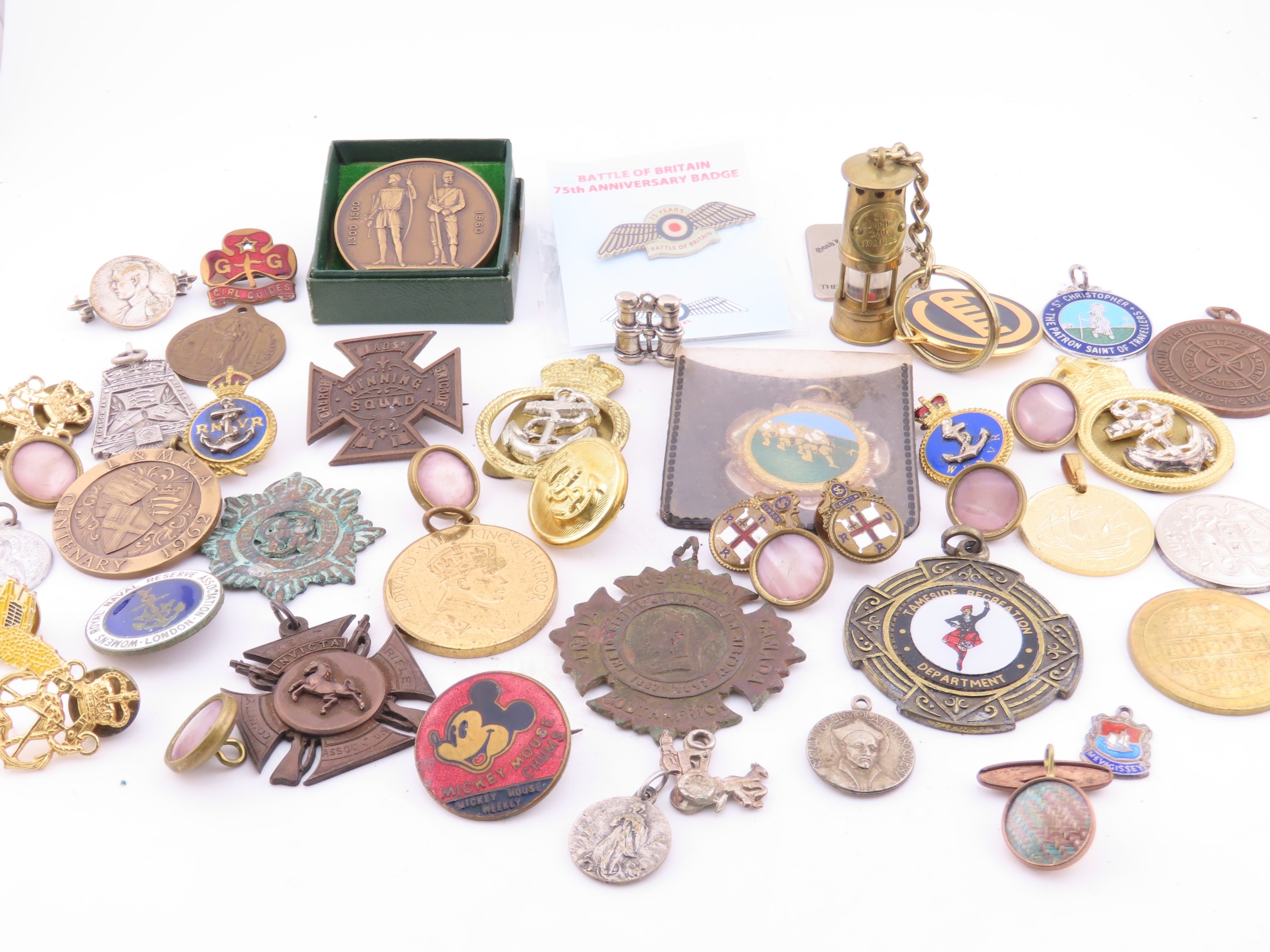 A mixed group of badges and medallions, including military and ...