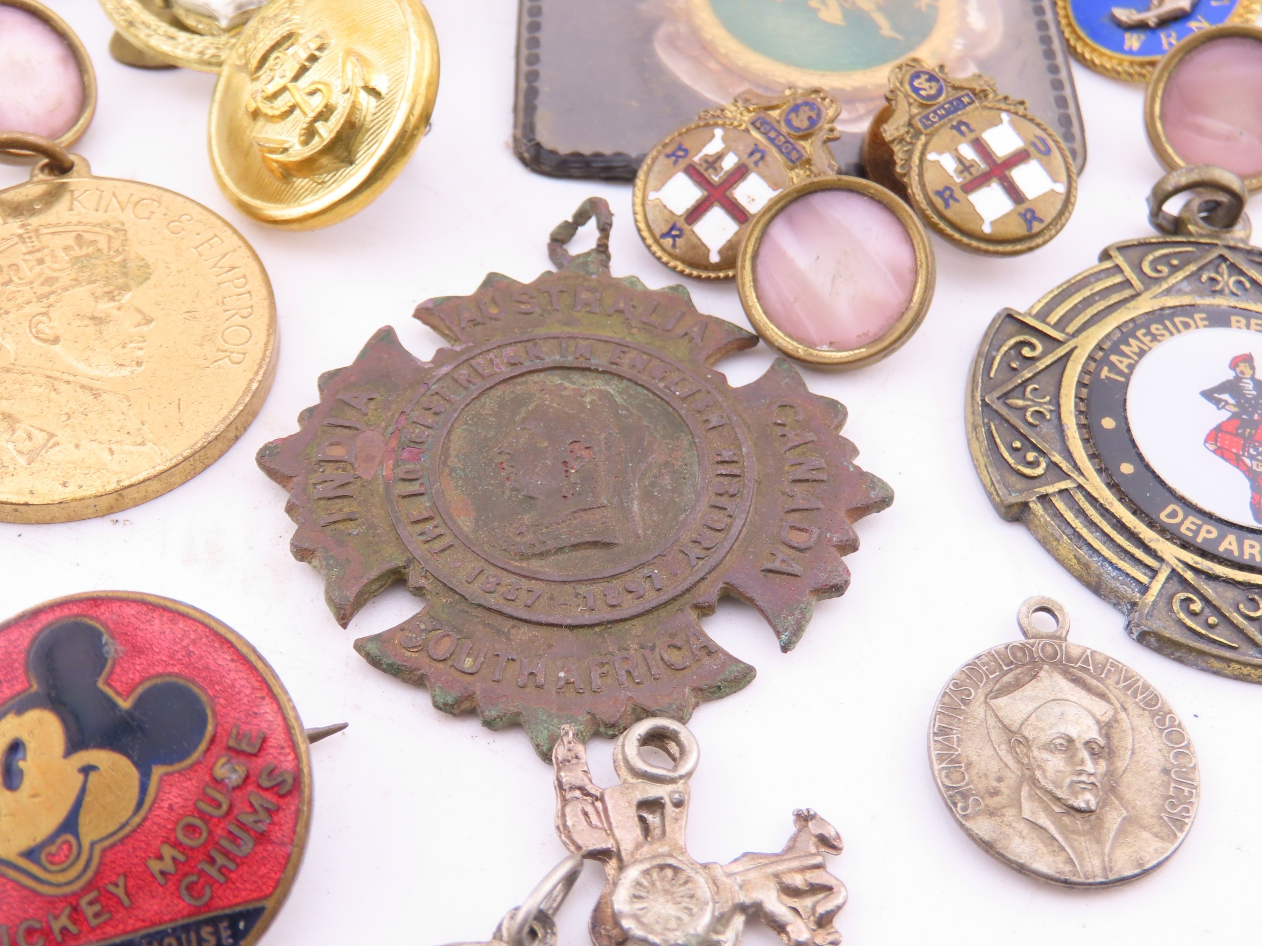 A mixed group of badges and medallions, including military and ...