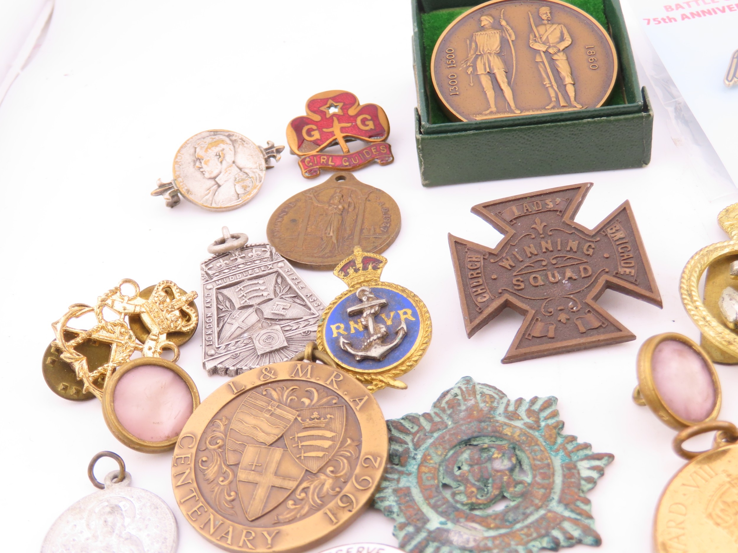 A mixed group of badges and medallions, including military and ...
