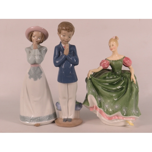 25 - Two Nao figurines (boy and girl in praying poses) and a Royal Doulton lady in green dress - tallest ... 