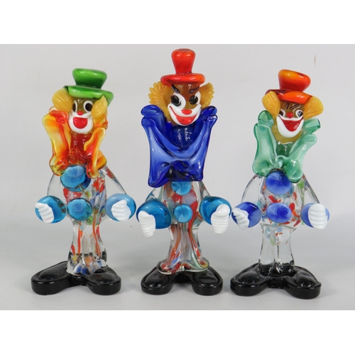 34 - Three Murano glass clown figurines in green, red and orange hats with bright multicoloured bodies an... 