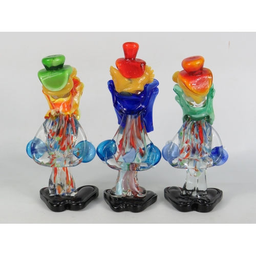 34 - Three Murano glass clown figurines in green, red and orange hats with bright multicoloured bodies an... 